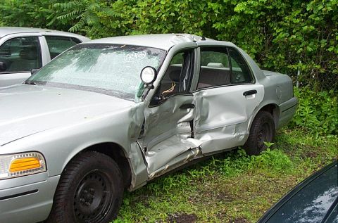 2001 Ford Crown Victoria - This 2001 Ford Crown Victoria shows significant damage to its driver's side, including the door and fender.
