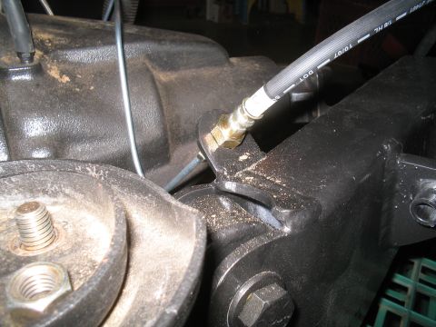 1979 Ford Bronco - Detail of a vehicle's brake system, showing a brake hose and suspension components.