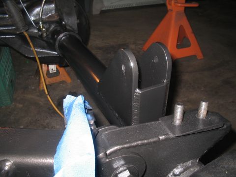 1979 Ford Bronco - A close-up view of a vehicle's suspension system, showing metal brackets and bolts.