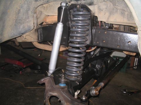1979 Ford Bronco - Close-up view of a vehicle's front suspension and steering system components.