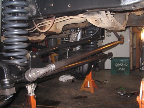 1979 Ford Bronco - Close-up view of the suspension and steering components of a vehicle, likely undergoing modifications or repairs.