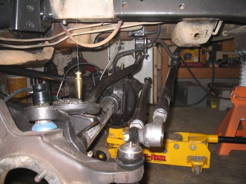 1979 Ford Bronco - The photo shows the underside of a vehicle, focusing on the steering and suspension system, possibly during a repair or modification.