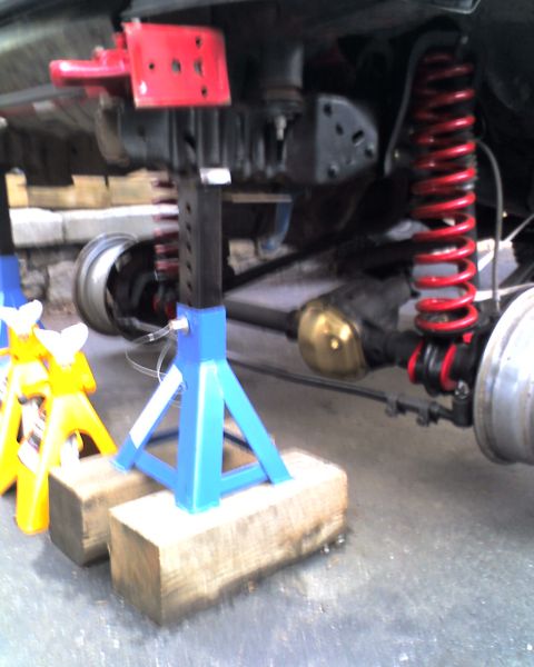 1996 Ford F-150 - Vehicle suspension parts are visible, supported by jack stands and wooden blocks.