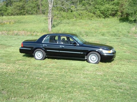 2001 Mercury Grand Marquis - This 2001 Mercury Grand Marquis is seen from a 3/4 front angle, parked in a grassy field.