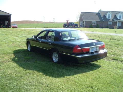 2001 Mercury Grand Marquis - Rear view of a black 2001 Mercury Grand Marquis parked on a sunny day.