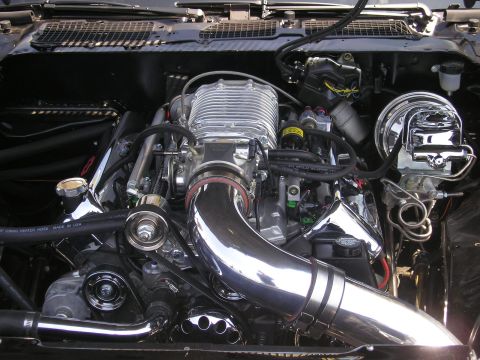 1995 Ford Bronco - Engine bay detail showing a polished supercharger and intake system on a V8.