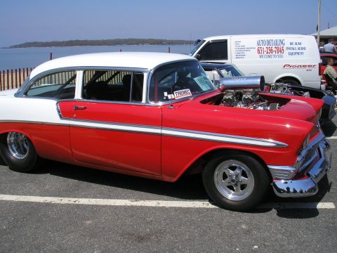 1995 Ford Bronco - This modified 1956 Chevrolet sedan features a prominent blower on its V8 engine and a two-tone red and white paint scheme.
