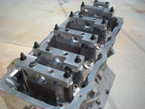 1964 Ford 427 - Close-up of an engine block installed main bearing caps and fasteners.