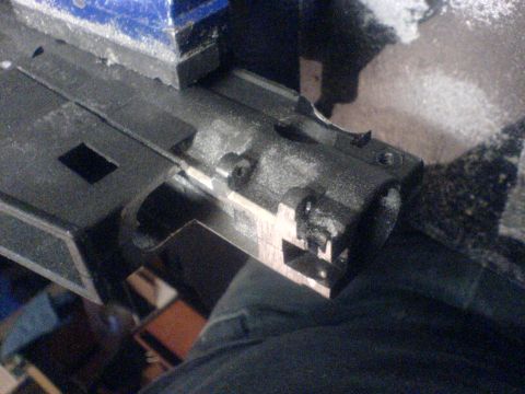 1985 Ford Bronco - A firearm bolt carrier group is held in a vise for work. The registry claims it is a 1985 Ford Bronco, which is incorrect.