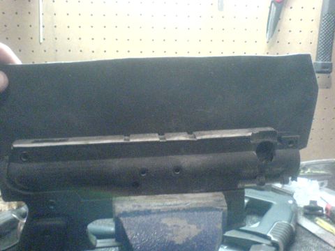 1985 Ford Bronco - A metal part is secured in a vise, possibly for repair or modification.