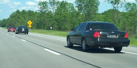 2001 Ford Crown Victoria - A black 2001 Ford Crown Victoria is seen driving on a highway.