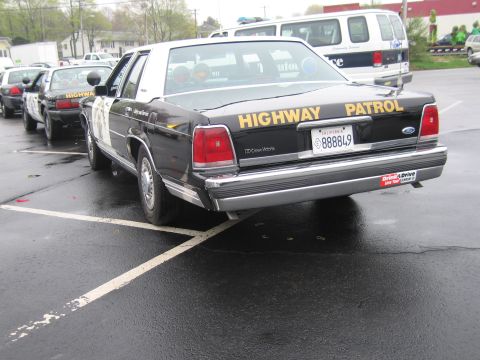 1991 Ford LTD Crown Victoria - black Ford Crown Victoria California Highway Patrol sedan shown from the rear, lettered Highway Patrol with plate 888849.
