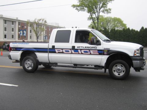 1991 Ford LTD Crown Victoria - Side profile of a white Attleboro Police Ford Super Duty crew cab traffic enforcement pickup truck.