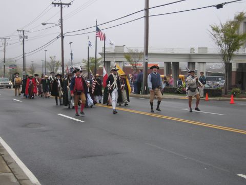 1991 Ford LTD Crown Victoria - group of Revolutionary War reenactors in tricorn hats march with flags and muskets down a foggy street.