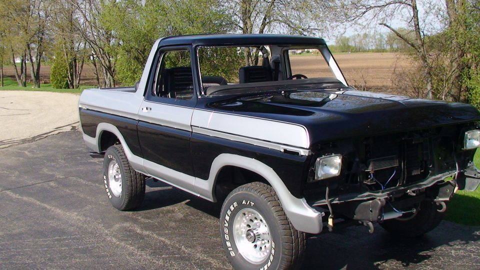 Black and silver Ford Bronco with front end damage