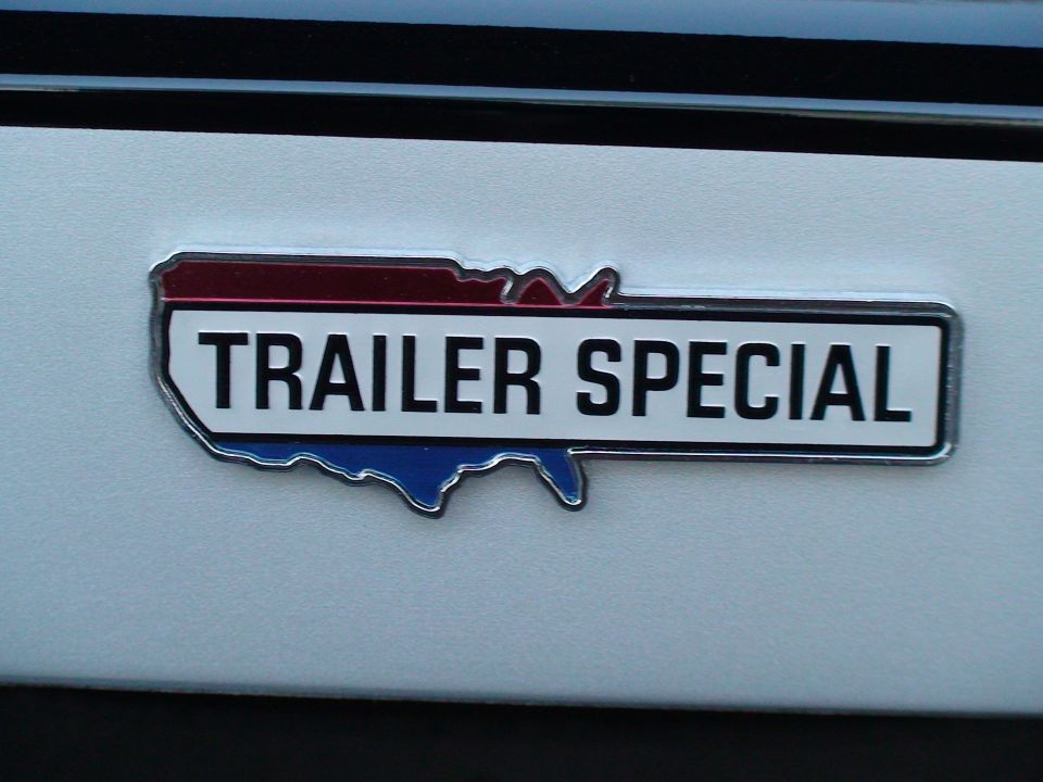 Chrome TRAILER SPECIAL emblem in USA map shape on white body panel