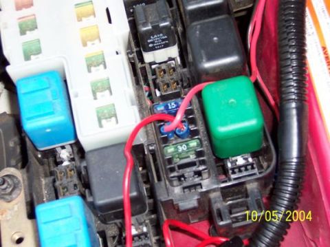 1995 Ford Probe - Close-up view of a vehicle's fuse box, showing various relays and fuses, including a 15A and a 30A fuse.