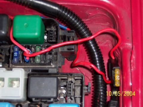 1995 Ford Probe - Automotive fuse box with red wiring and a green relay visible.