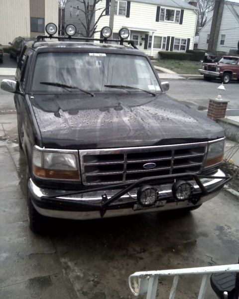 1995 Ford Bronco - Front view of a 1995 Ford Bronco equipped with auxiliary lights on the roof and bumper.