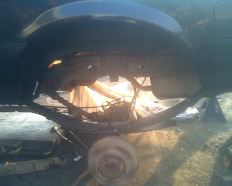 1995 Ford Bronco - Undercarriage view showing the rear axle and leaf spring suspension system.
