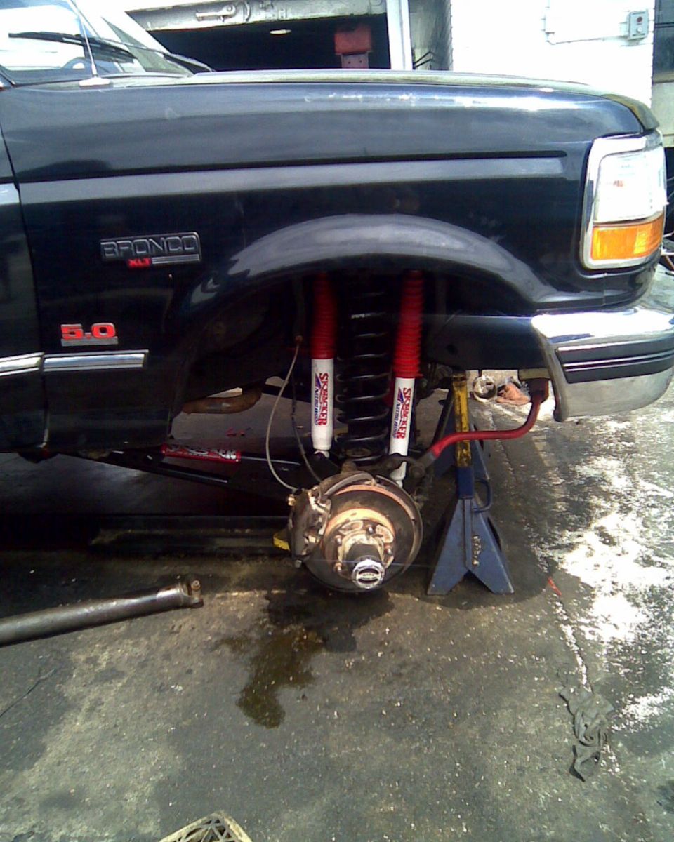 1995 Ford Bronco front quarter, lifted with red shocks