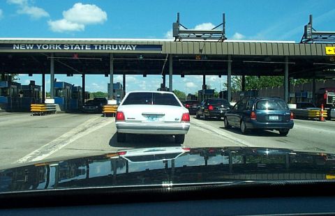 2001 Ford Crown Victoria - Cars queue at the New York State Thruway toll plaza under a blue sky.