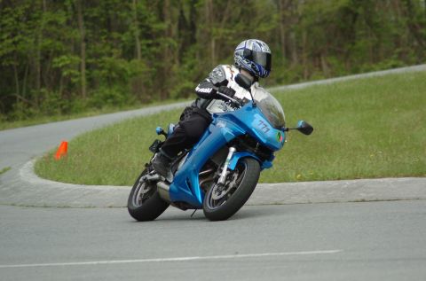 2007 Kawasaki Ninja R - A rider navigates a curve on a blue sportbike, with a number '771' visible on the fairing.