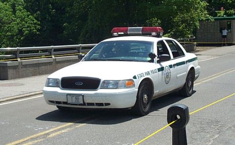 2001 Ford Crown Victoria - A 2001 Ford Crown Victoria police car is parked on the side of a road.