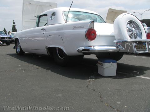 1968 Ford Mustang - Rear view of a white 1957 Ford Thunderbird with its hood open and a continental kit.