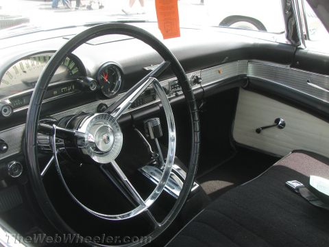1968 Ford Mustang - The interior of a 1955 Ford Thunderbird features a distinctive steering wheel and dashboard design.