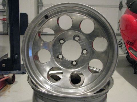 2008 Ford Bronco - A close-up of an aluminum wheel is shown, with a red scooter visible in the background.