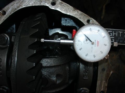 1978 Ford Bronco - Close-up of differential gears being measured with a dial indicator, likely for backlash adjustment.