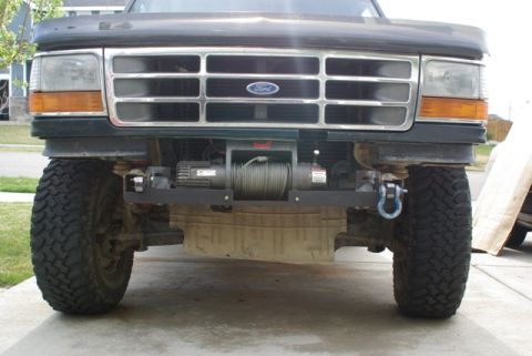 1995 Ford Bronco - This Ford truck features a winch and tow hook, indicating off-road capabilities.