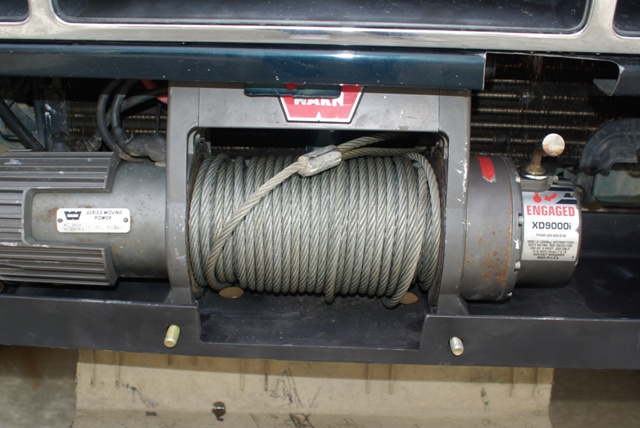 Warn XD9000i winch with steel cable on drum, clutch lever set to ENGAGED