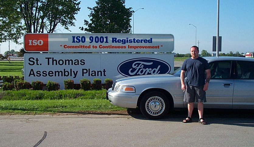 Silver Ford Crown Victoria parked at the St. Thomas Assembly Plant Ford sign