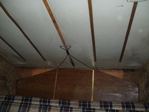 1980 Ford Bronco - The interior of a camper shows wood paneling on the ceiling and a glimpse of the living space below.