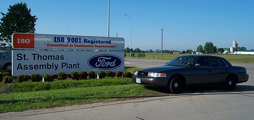 Dark gray 2001 Ford Crown Victoria parked by a sign for St. Thomas Assembly Plant