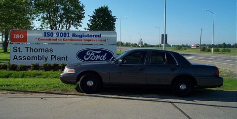 2001 Ford Crown Victoria - A Ford Crown Victoria is parked next to the St. Thomas Assembly Plant sign.