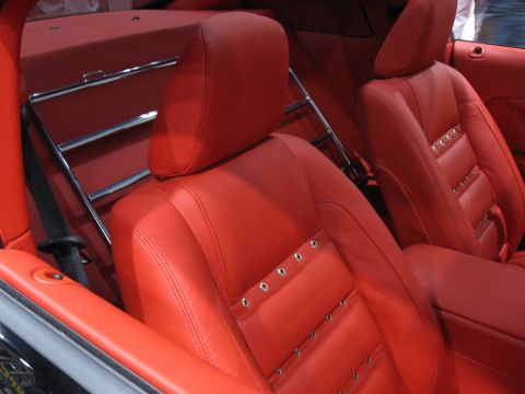 1998 Ford Crown Victoria - Interior view of red leather seats with chrome accents and a luggage rack.