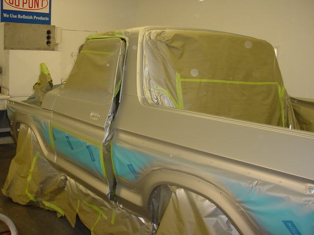 Silver 1979 Ford Bronco in 3/4 front view, masked for painting