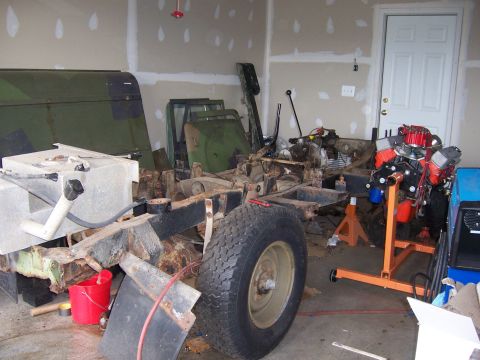 1974 Land Rover Land Rover - Disassembled Land Rover chassis and engine components are stored in a garage.