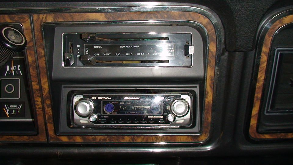 1979 Ford Bronco dashboard with wood trim, Pioneer stereo, and climate controls.