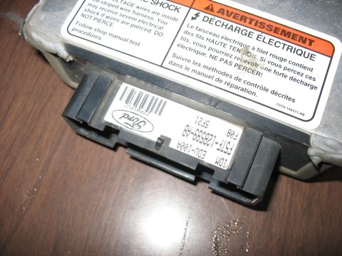 1995 Ford C-350 (Centurion Conversions) - A close-up view of a vehicle's electronic control unit, showing its identification label.