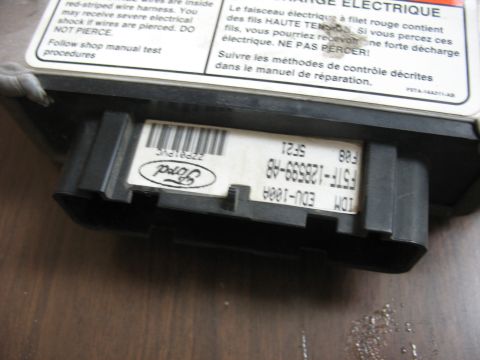 1995 Ford C-350 (Centurion Conversions) - Close-up of a Ford electronic control module, showing labels and connectors.