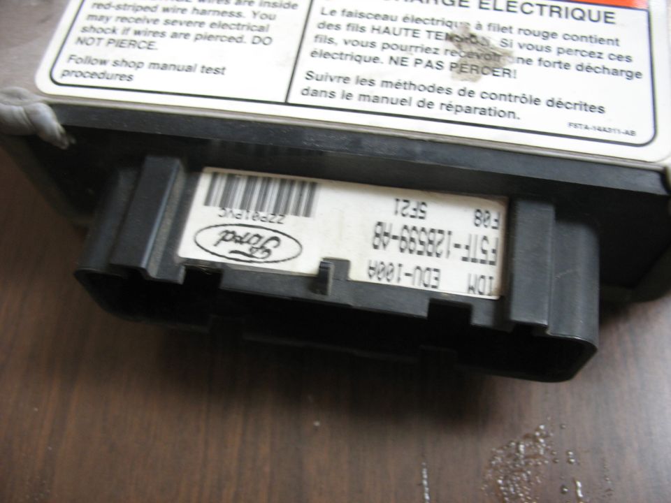 Ford electronic control module with part number F5TF-12B559-A8 and Ford logo