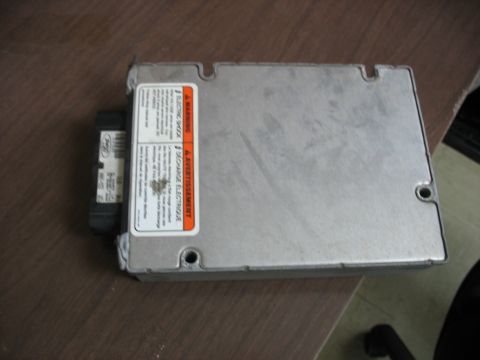1995 Ford C-350 (Centurion Conversions) - This is a Ford electronic control module, likely an engine control unit, with warning labels indicating electrical discharge hazards.