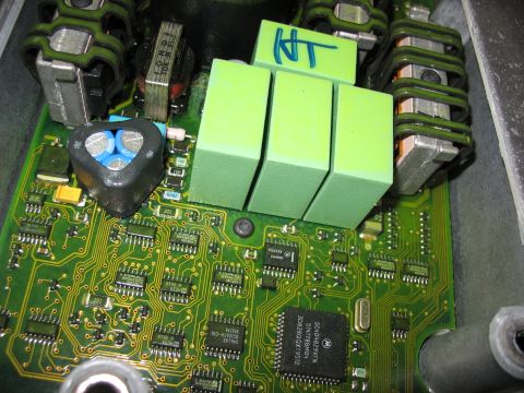 1995 Ford C-350 (Centurion Conversions) - An electronic control unit is shown with green capacitors and numerous integrated circuits on its green circuit board.