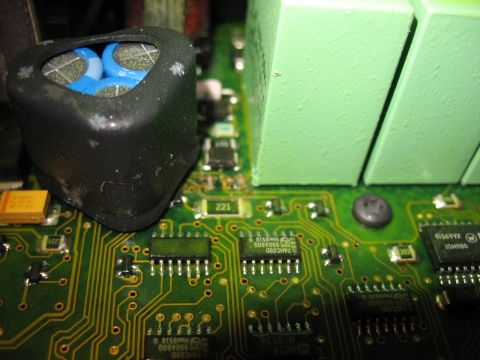 1995 Ford C-350 (Centurion Conversions) - Close-up view of electronic components on a green circuit board, including capacitors and microchips.