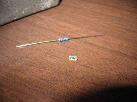 1995 Ford C-350 (Centurion Conversions) - Two electronic components, a resistor and a small chip, are shown on a wooden surface.