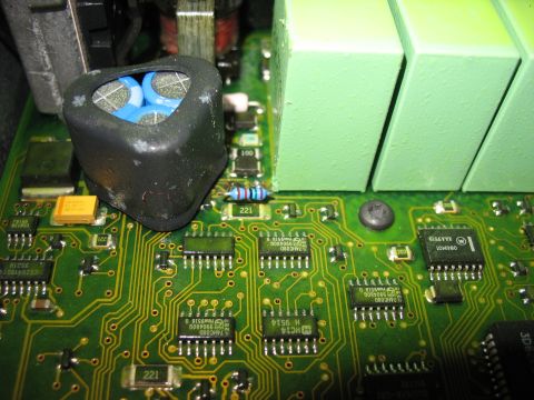 1995 Ford C-350 (Centurion Conversions) - A detailed view of electronic components on a green circuit board, including a prominent capacitor and various microchips.